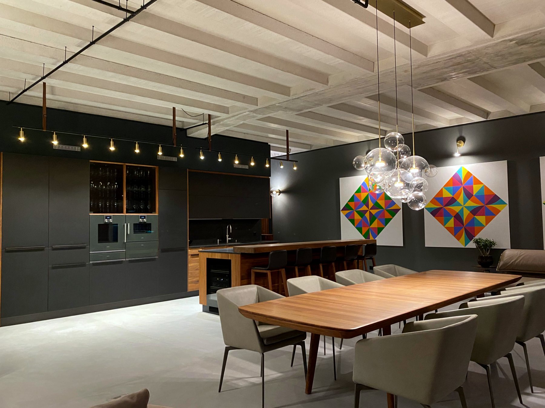 Kitchen with walnut island, geometric paintings and exposed beamed ceiling
